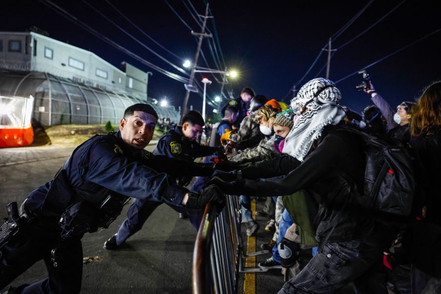 Police hold a barricade as protestors push outside Delaney Hall, which is being used as an ICE detention center, during clashes last month.