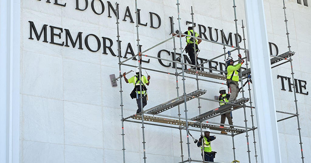 Workers stand on scaffolding outside the Kennedy Center on June 12, 2026, ahead of a deadline to remove President Trump's name from the building.