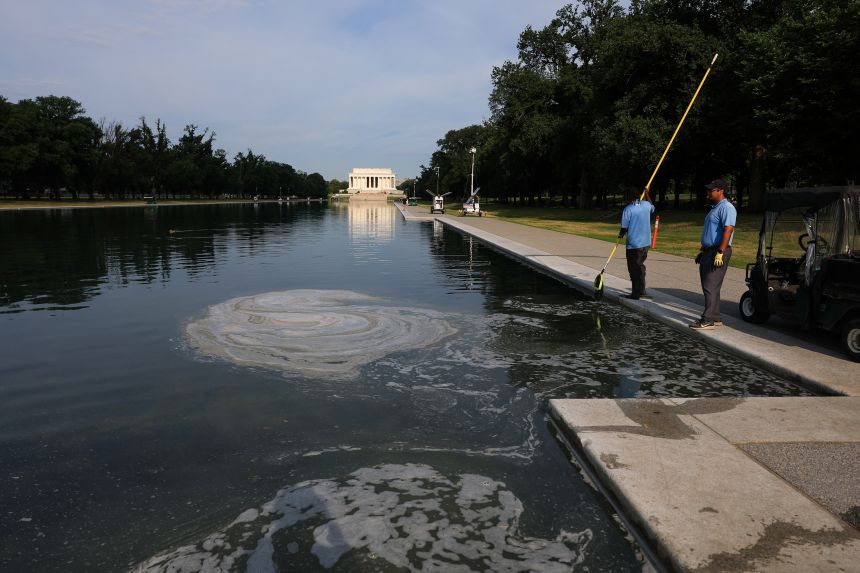 Workers clean the Lincoln Memorial Reflecting Pool on June 25, 2026.