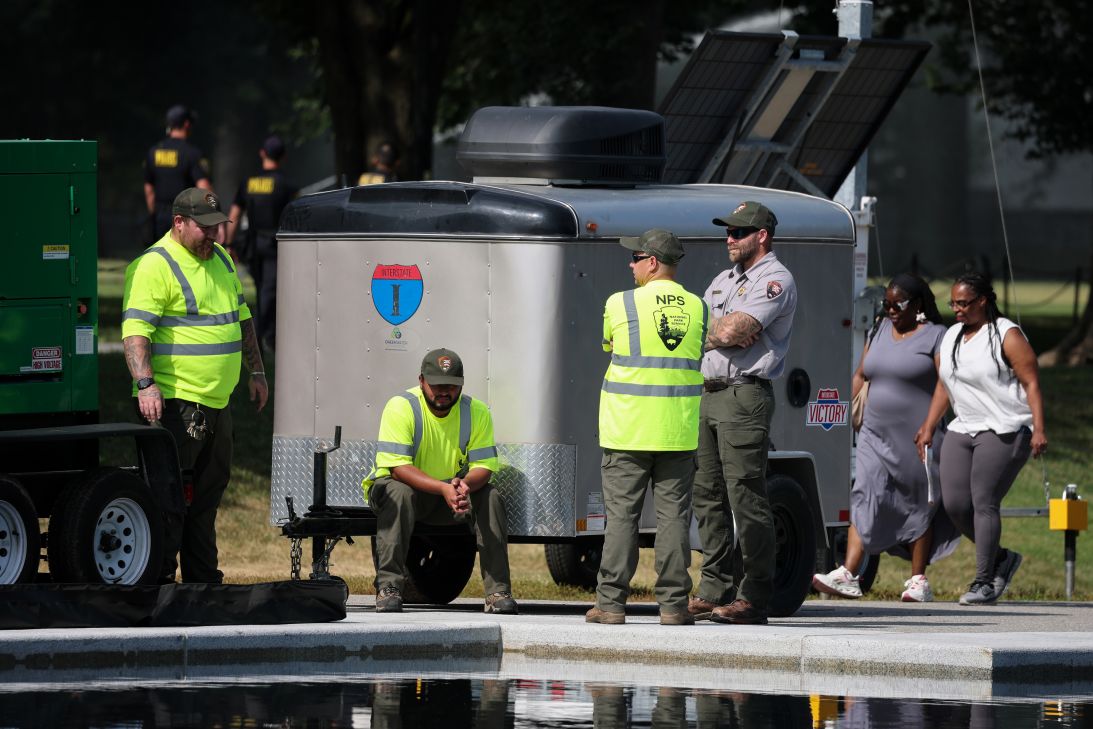 National Park Service employees look on as work continues at the Lincoln Memorial Reflecting Pool on the National Mall on June 25, 2026.