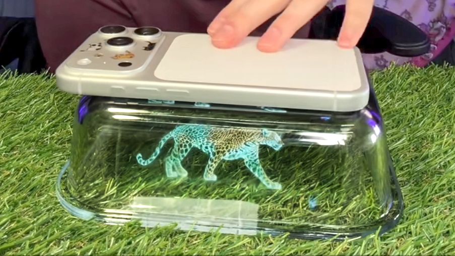 Screenshot of TikTok video showing DIY hologram projector using your phone and a rectangular glass dish.
