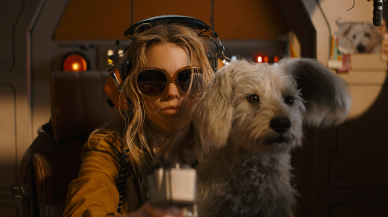 Milly Alcock as Supergirl with Krypto on her lap in Supergirl (2026)
