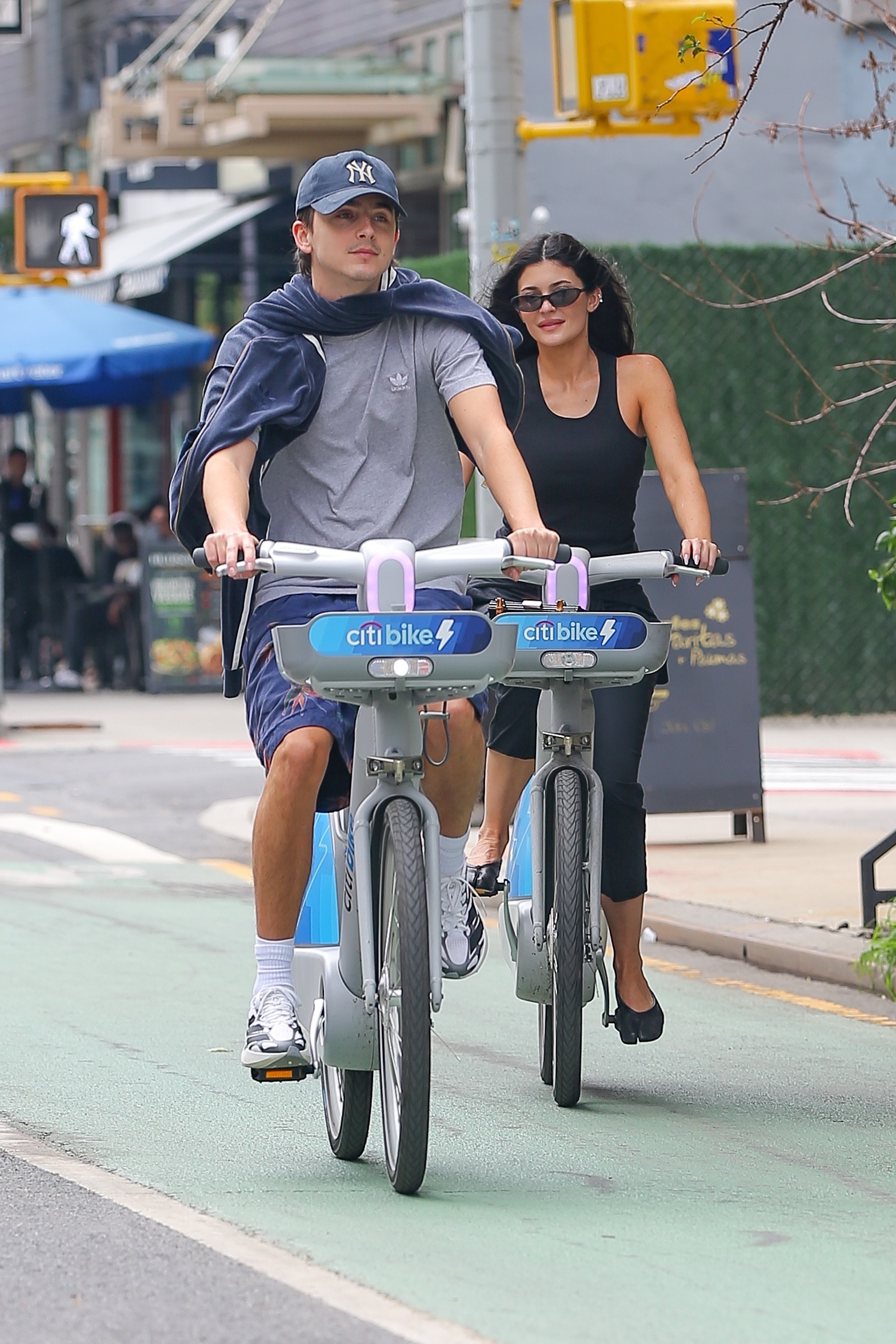 Kylie Jenner wears Maison Margiela Tabi Ballerina Flats on a Citi Bike with Timothee Chalamet