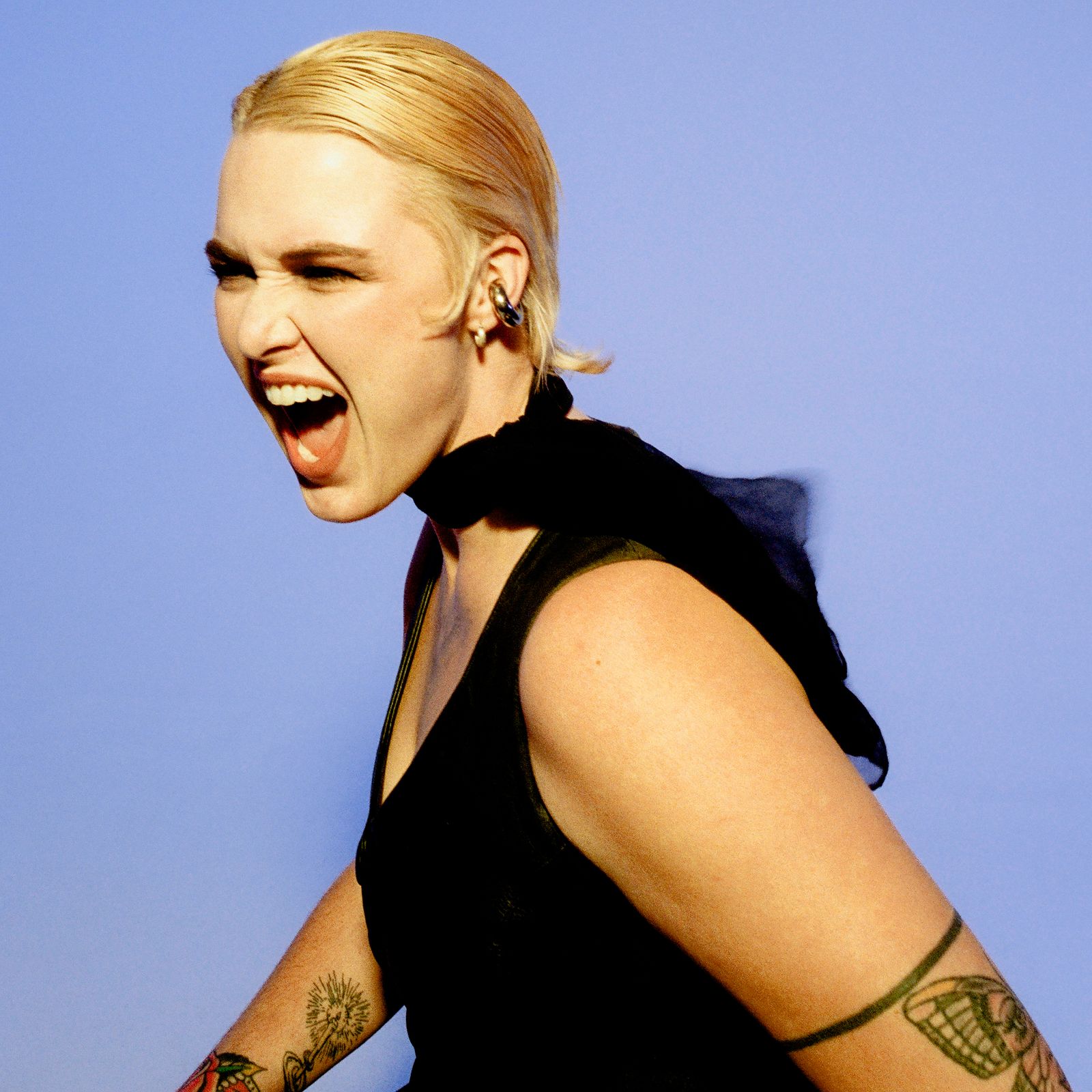 Image may contain Head Person Face Happy Laughing Adult Photography Portrait Skin Tattoo Angry and Shouting