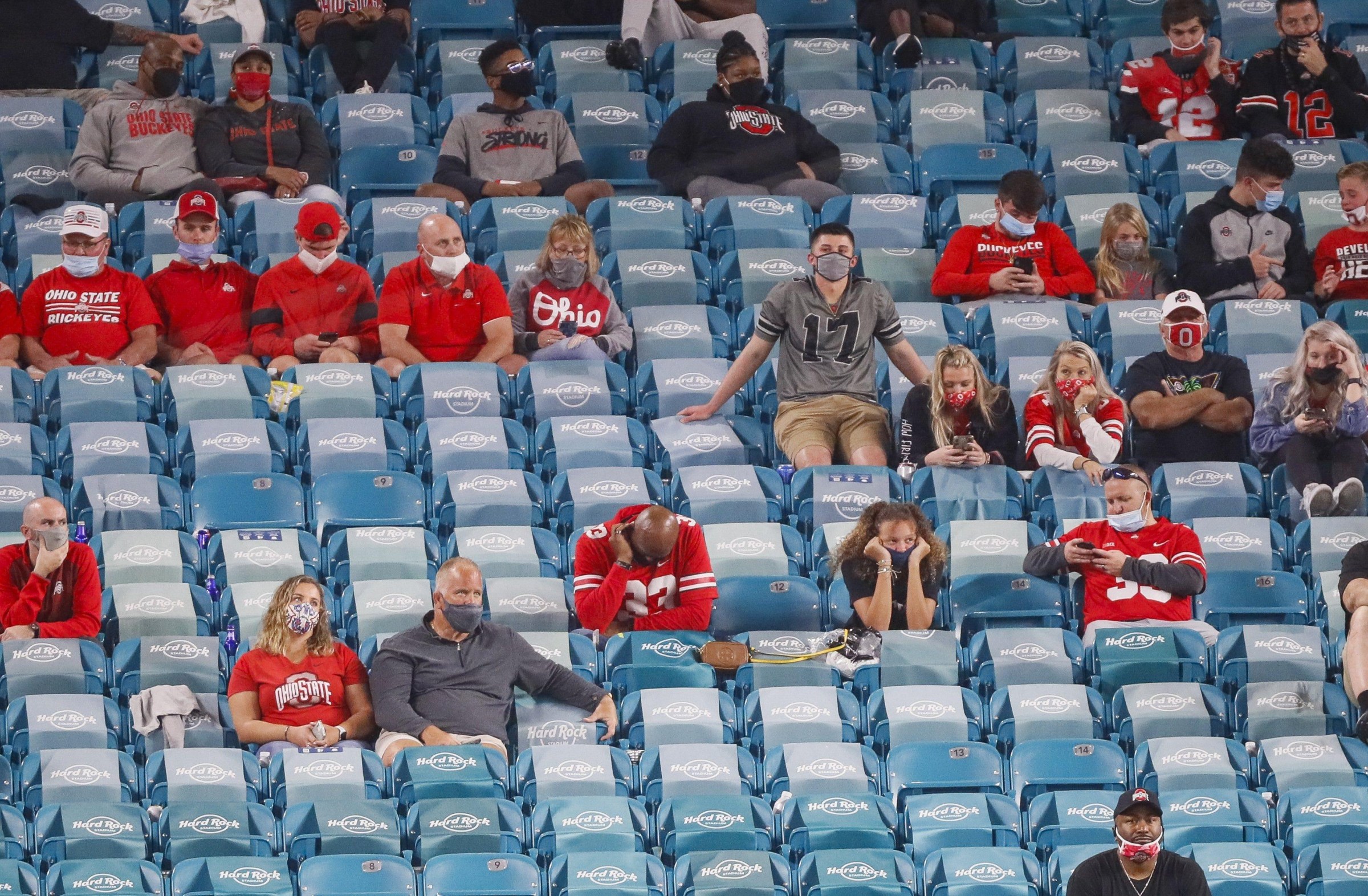 Jan. 11, 2021; Miami Gardens, Florida, USA; Ohio State Buckeyes fans look dejected as they watch the game against the Alabama Crimson Tide during the fourth quarter of the College Football Playoff National Championship at Hard Rock Stadium in Miami Gardens, Fla.