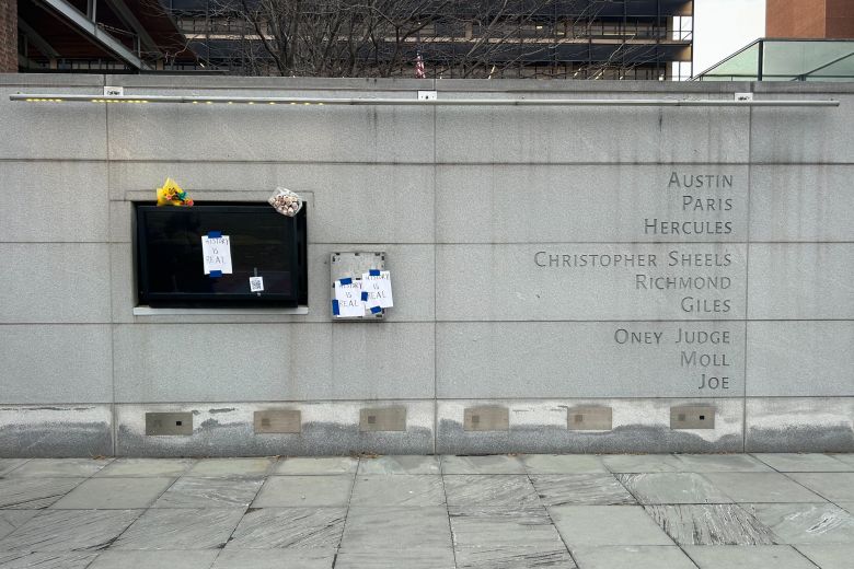 Protest signs are displayed at the President’s House in Philadelphia on January 23, the day after the National Park Service removed a long-standing exhibit on slavery from the location. The names of nine enslaved people who once worked in the house are engraved on one side of the site.