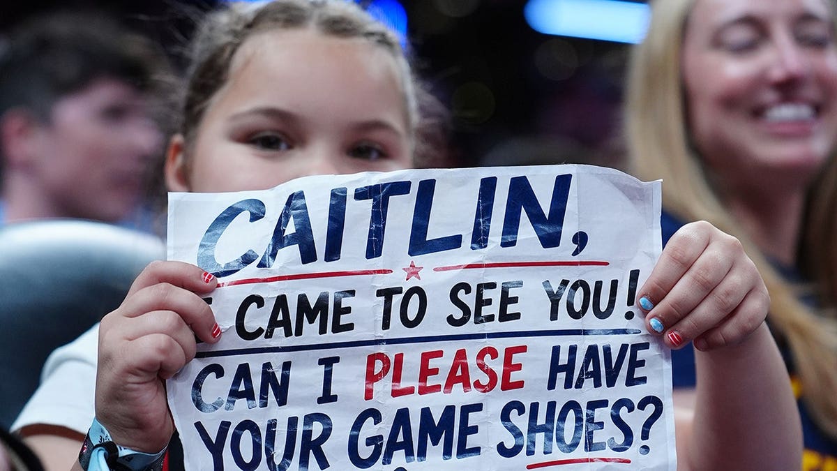 Indiana Fever fan holding up a sign during a game at Gainbridge Fieldhouse in Indianapolis