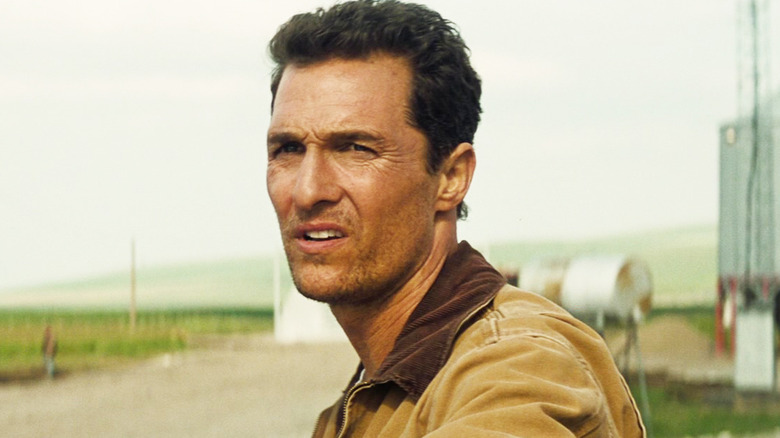 Matthew McConaughey's Joseph "Coop" Cooper looks off into the distance as he stands outside in Interstellar