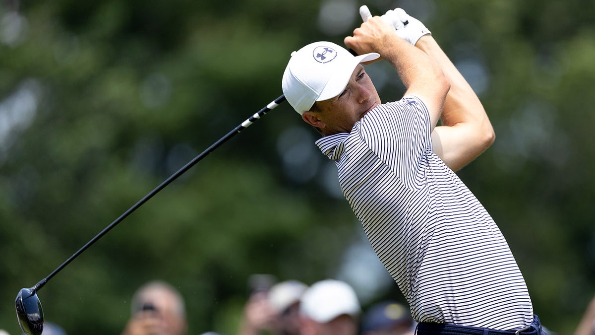 Jordan Spieth playing a shot from the first tee at the Travelers Championship golf tournament.