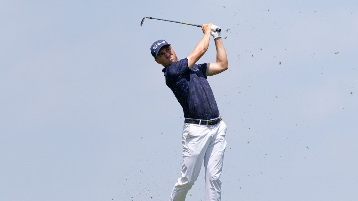 Justin Thomas hits an approach shot at the 14th hole during the 2025 Travelers Championship at TPC River Highlands.