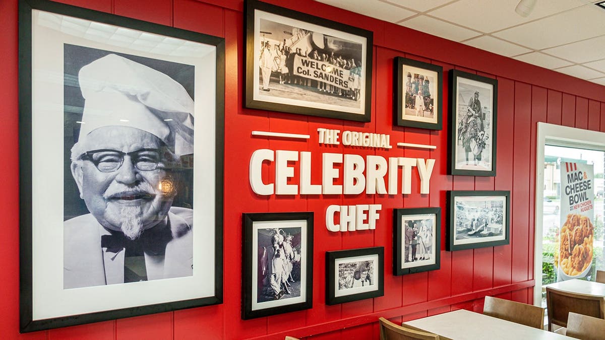 A wall with photos from KFC history.