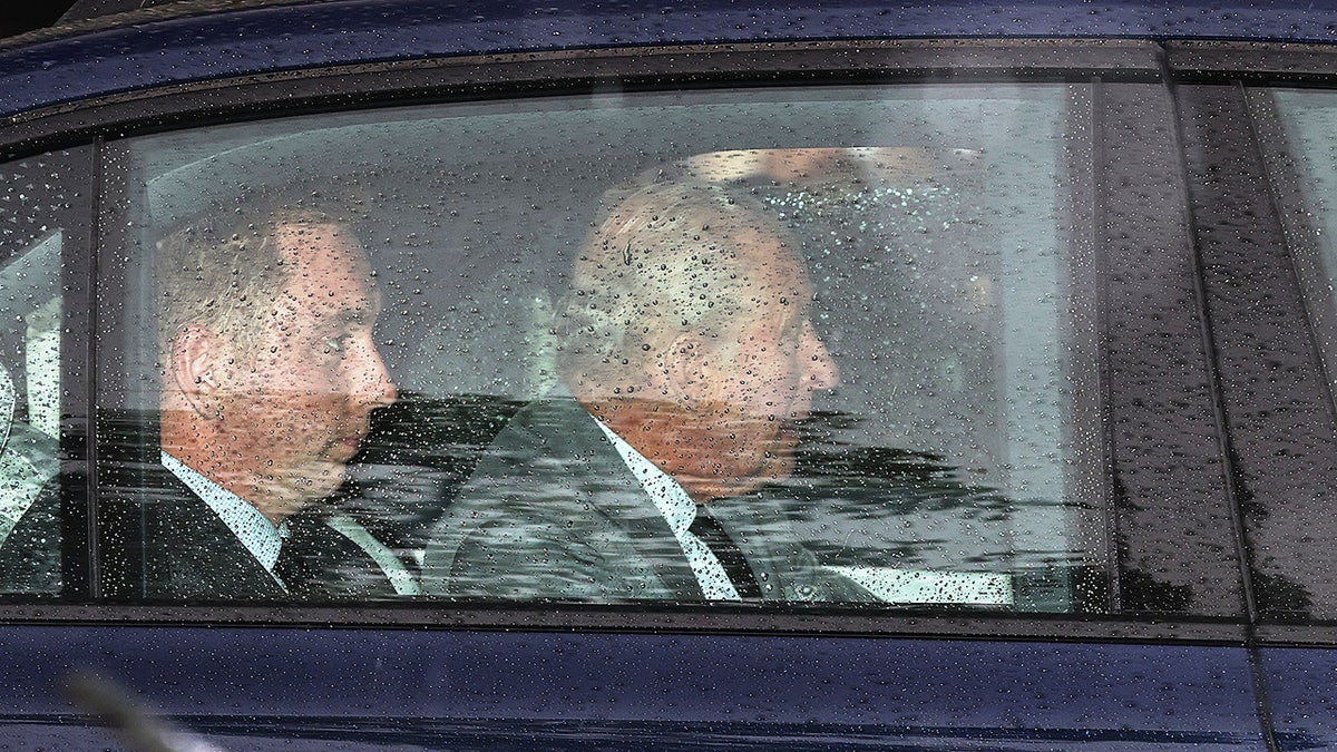 King Charles III arriving at Clarence House in London inside a car on a rainy day