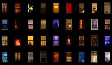 a composite grid of nighttime photographs of windows in New York City