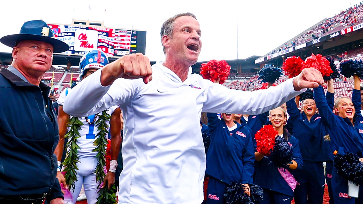 Ole Miss Rebels head coach Lane Kiffin celebrating with fans at Gaylord Family-Oklahoma Memorial Stadium
