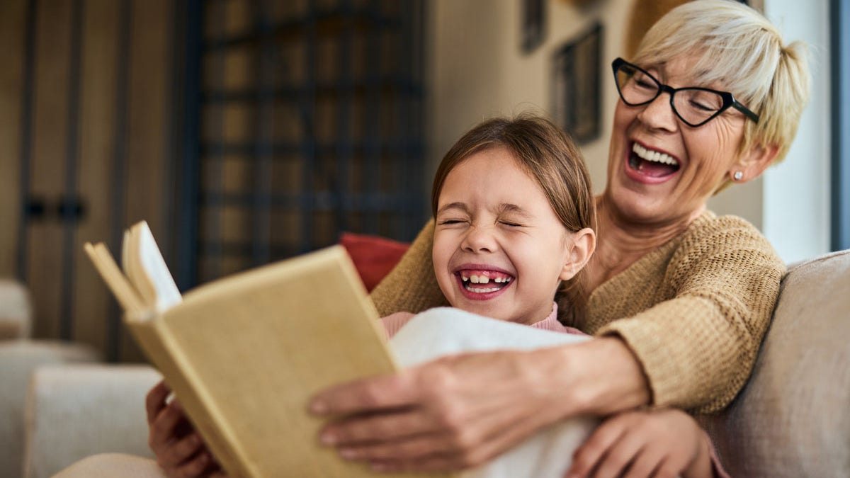 Grandma laughing with grandchild in a bright setting