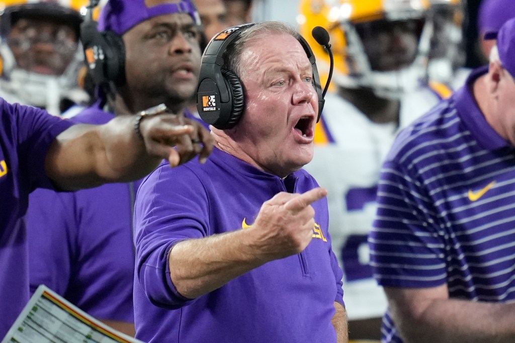 LSU head coach Brian Kelly shouting on the field during a game.