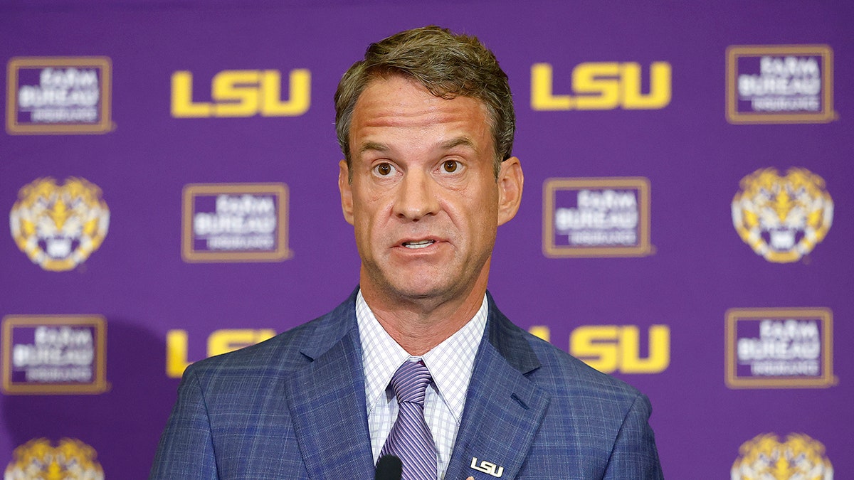 Lane Kiffin speaking at a press conference at Tiger Stadium in Baton Rouge, Louisiana.