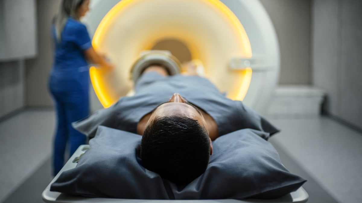 Man going into full-body MRI scan