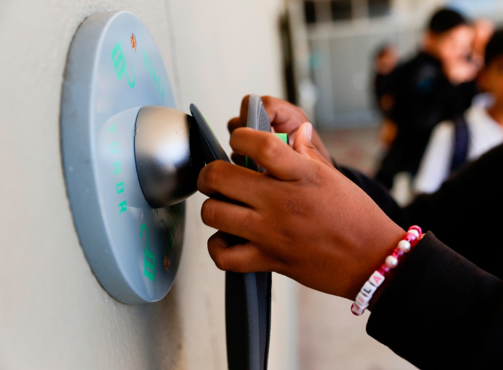 A student unlocks a Yondr pouch at Bayside Academy.