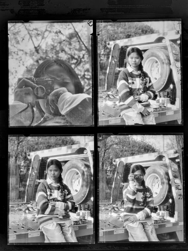 Four black-and-white photos show a young girl with pigtails, posing and holding a camera. She sits near a large, circular metallic object outdoors, with trees and blurred foliage in the background.