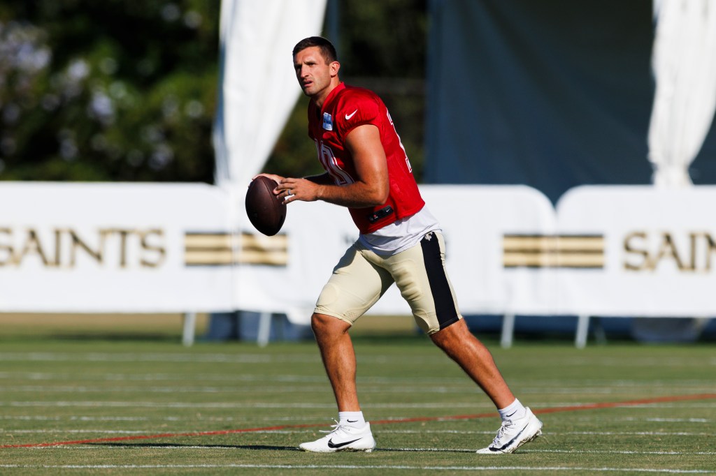 New Orleans Saints player holding a football during training camp.