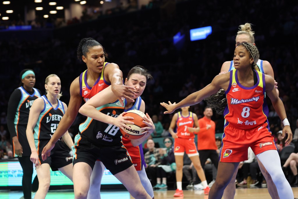 New York Liberty's Pauline Astier (18) grabbing a rebound over Phoenix Mercury's Alyssa Thomas.