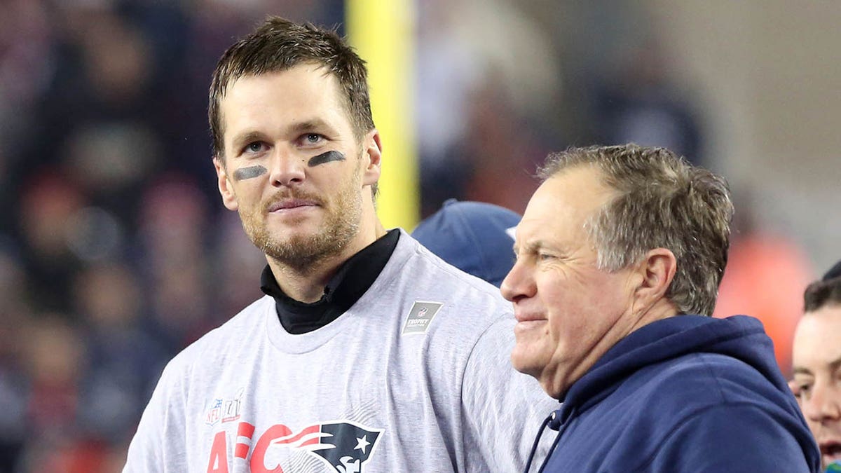 New England Patriots quarterback Tom Brady standing with head coach Bill Belichick at Gillette Stadium.