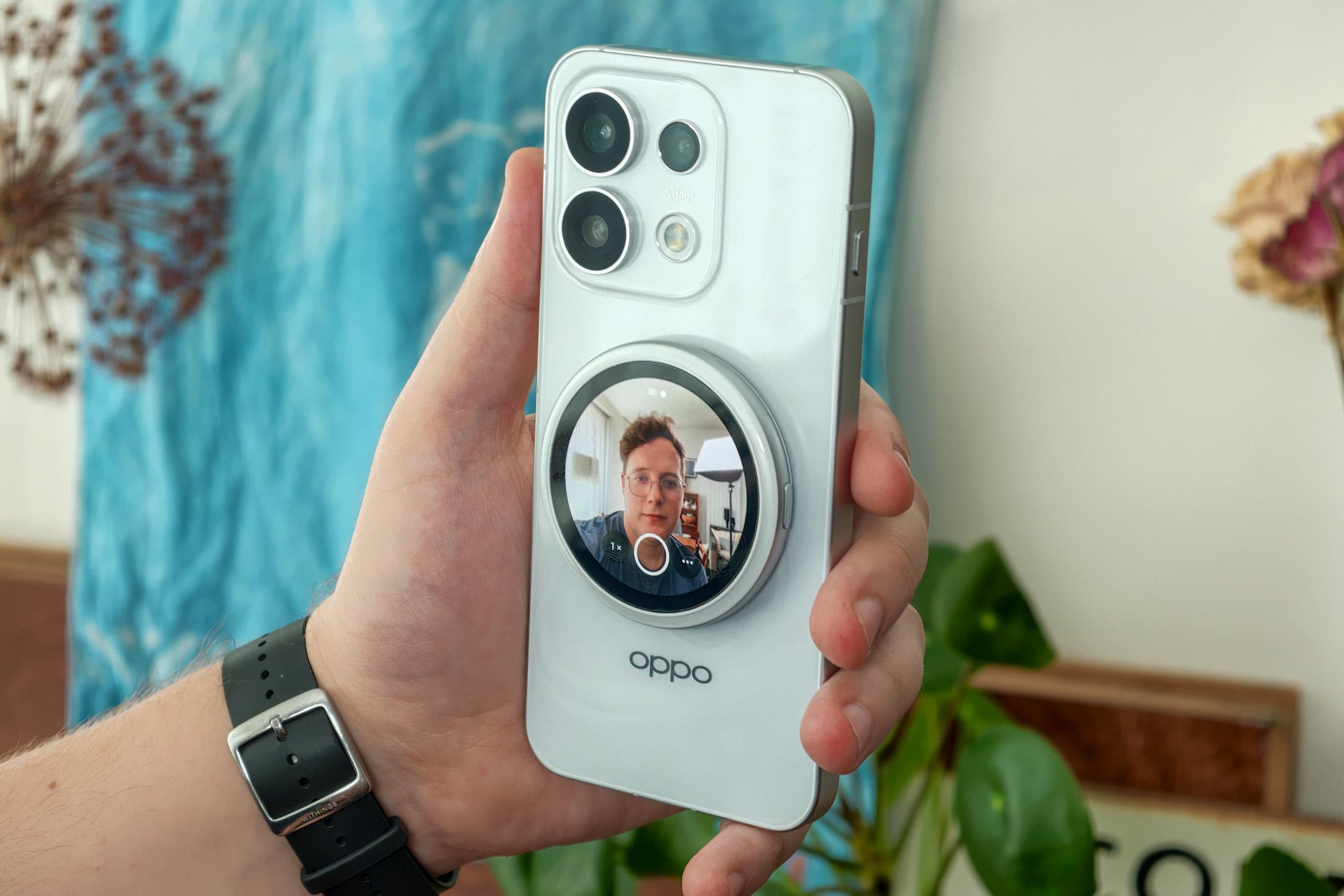 Photo of Oppo Bubble attached to a Reno 16 Pro taking a selfie