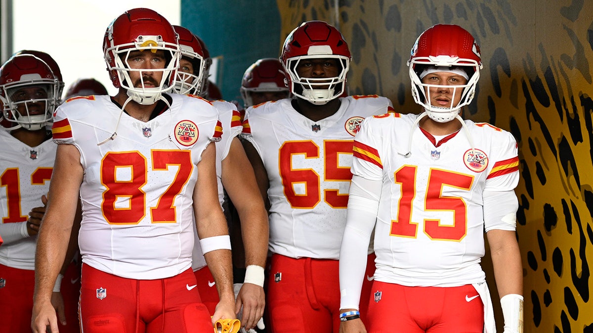 Kansas City Chiefs tight end Travis Kelce and quarterback Patrick Mahomes standing on the field.
