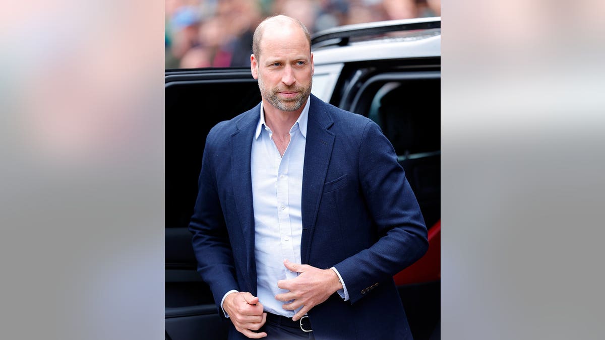 Prince William exiting a chauffeur-driven Land Rover Discovery in London.