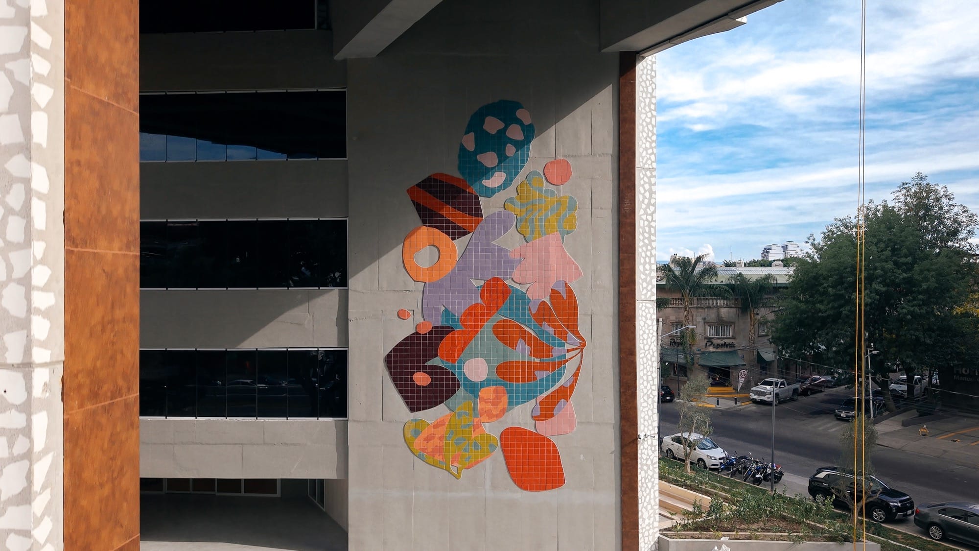 a mural by Alex Proba of colorful ceramic tiles in the shape of plants