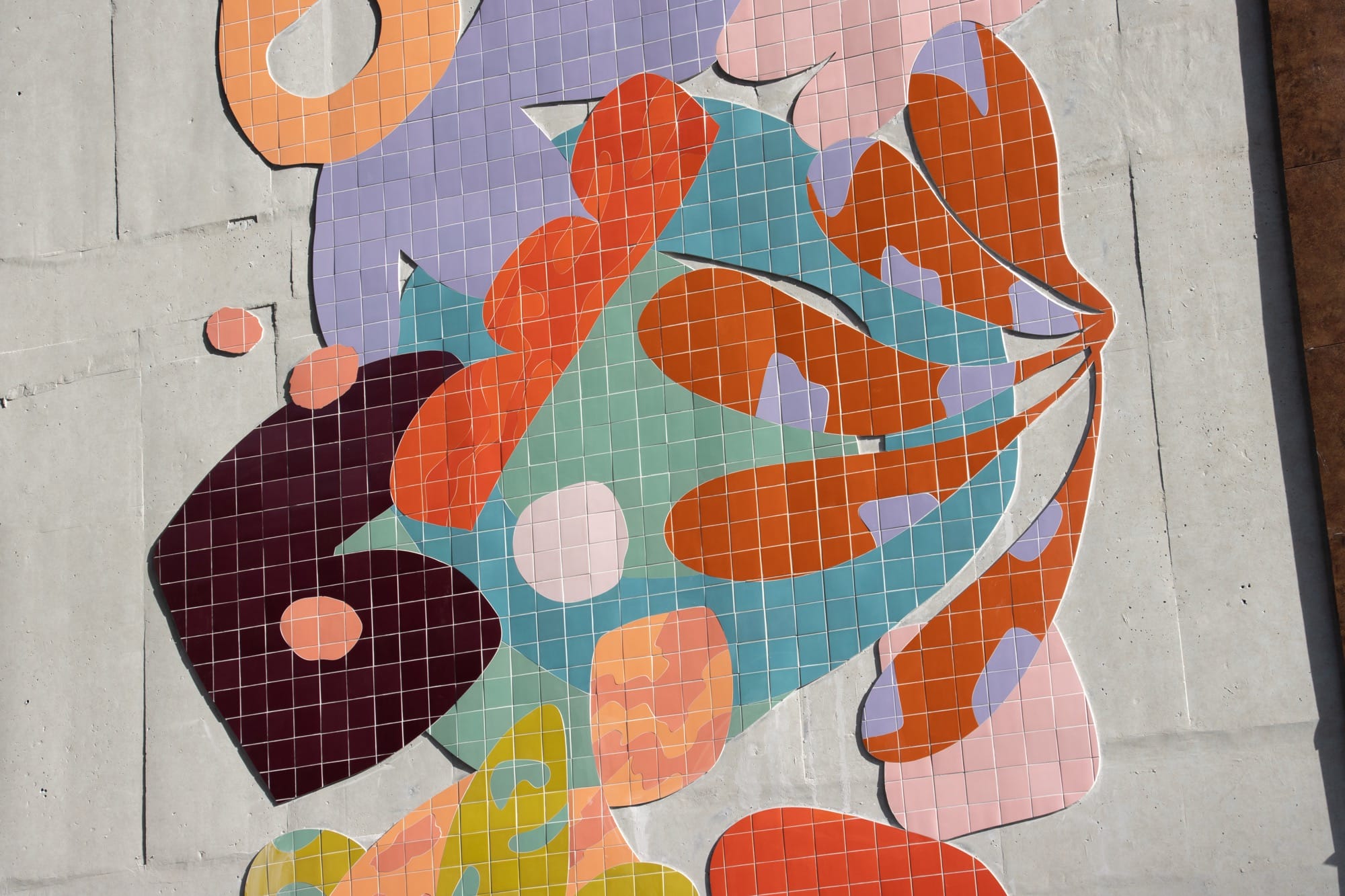 a mural by Alex Proba of colorful ceramic tiles in the shape of plants