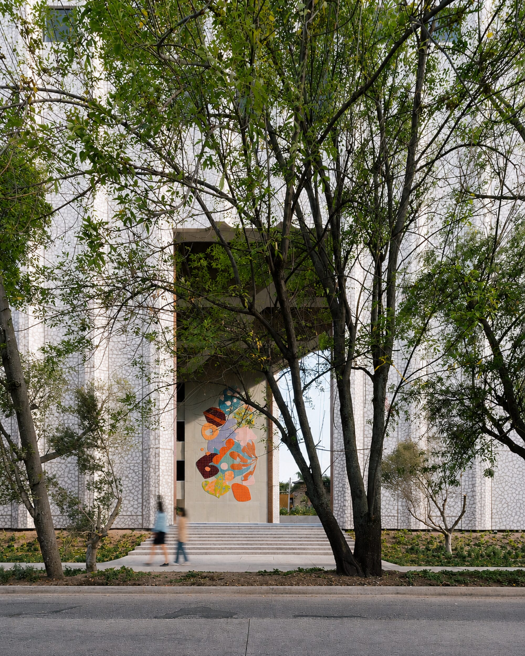 a mural by Alex Proba of colorful ceramic tiles in the shape of plants