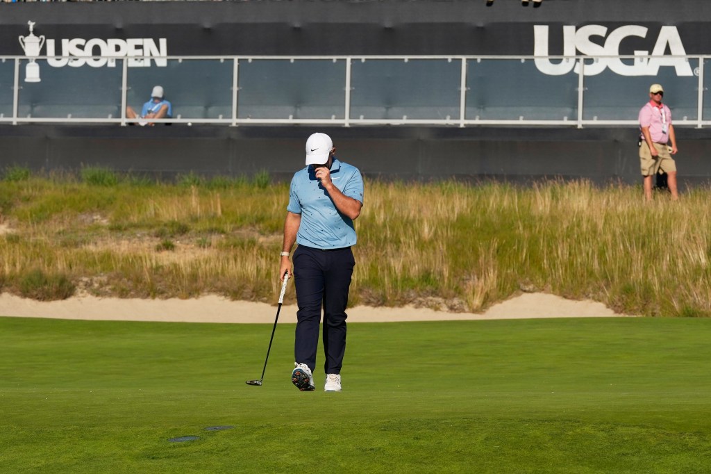 Rory McIlroy, of Northern Ireland, reacts after missing a putt on the 16th hole during the third round of the U.S. Open golf tournament at Shinnecock Hills Golf Club in Southampton, N.Y.