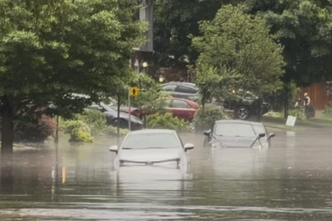 Cars are partially submerged in floodwater in Dollard-des-Ormeaux on Saturday after a series of storms.