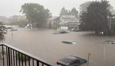 Cars are nearly submerged under floodwater after a storm.