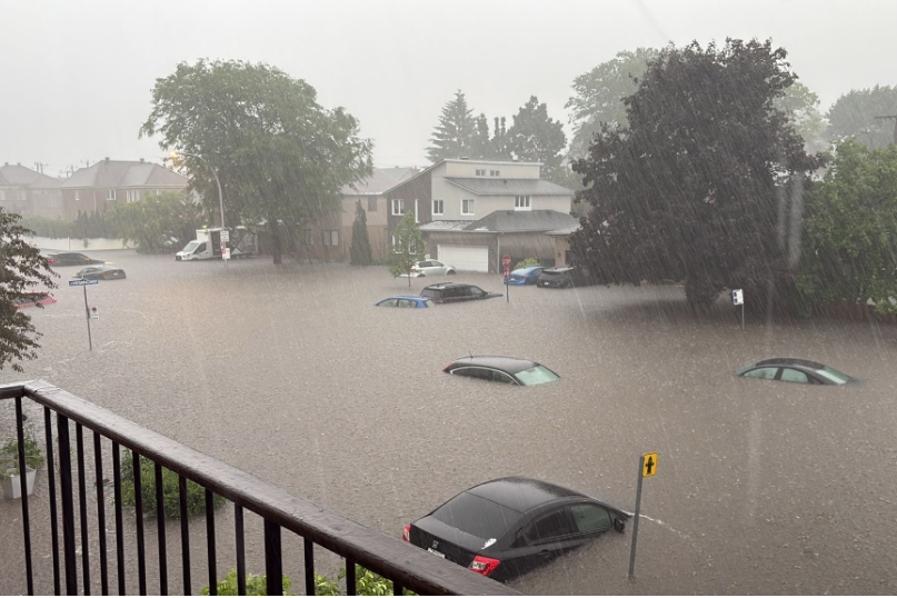 Cars are nearly submerged under floodwater after a storm.