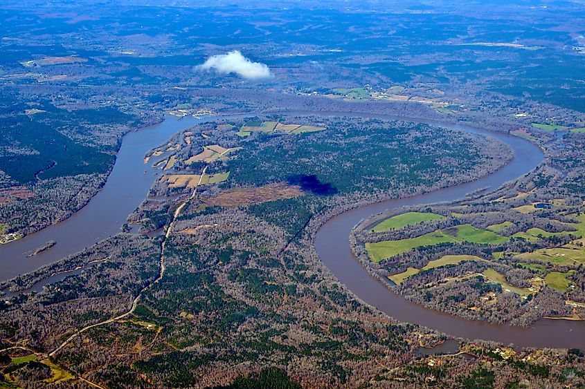 The Coosa River flowing past green agricultural land