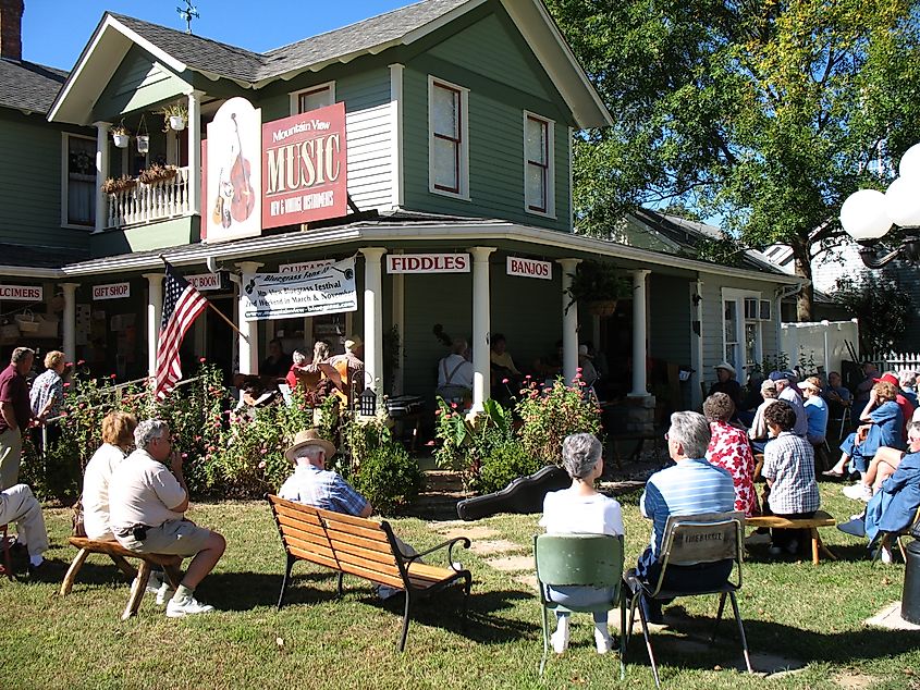 A crowd gathers for a porch music performance in Mountain View, Arkansas.