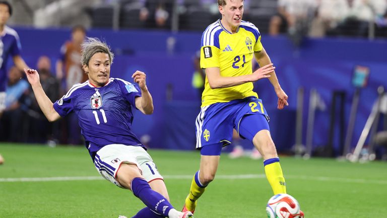 Japan's Daizen Maeda (11) scores his team's first goal 