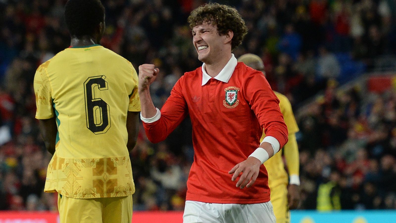 Lewis Koumas celebrates scoring his first international goal
