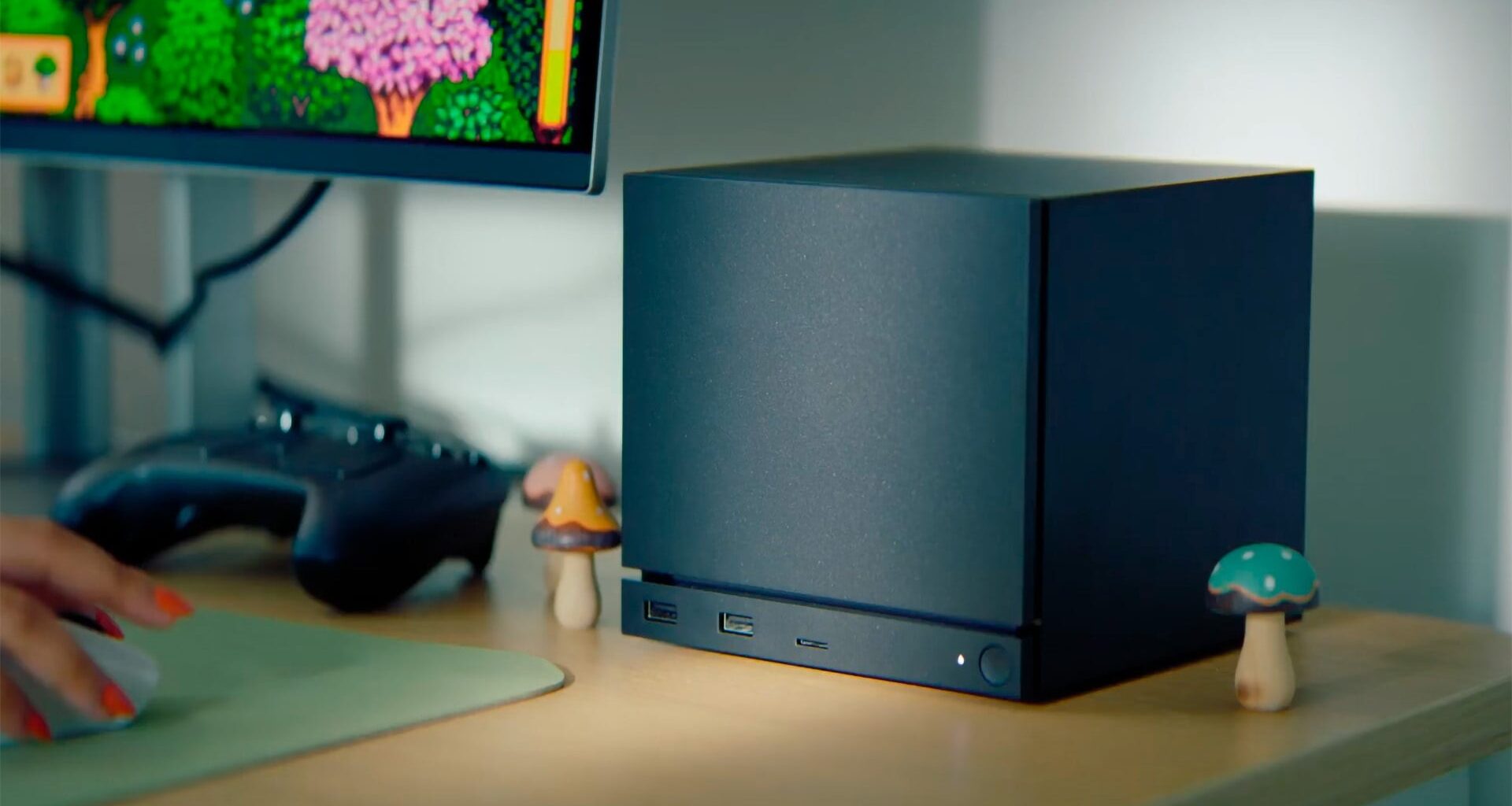 A Steam Machine sits on a desk.