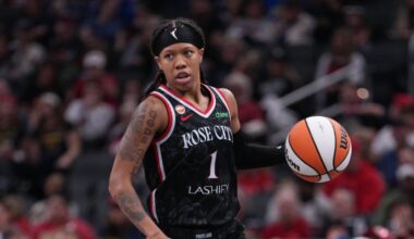 Sug Sutton dribbles up the court in a Portland Fire jersey during a game against the Indiana Fever