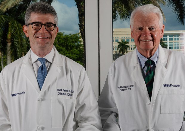 Dr. Chad Perlyn, executive vice president and chief medical officer, left, and Dr. Harry Moon, president of Nova Southeastern University, are seen in the boardroom on the Davie campus. Perlyn sees big donations transforming healthcare. (Joe Cavaretta/South Florida Sun Sentinel)