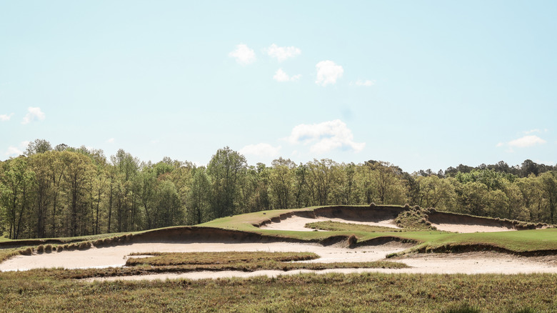 View of the unique landscape at Tobacco Road Golf Club in North Carolina with steep bunkers visible