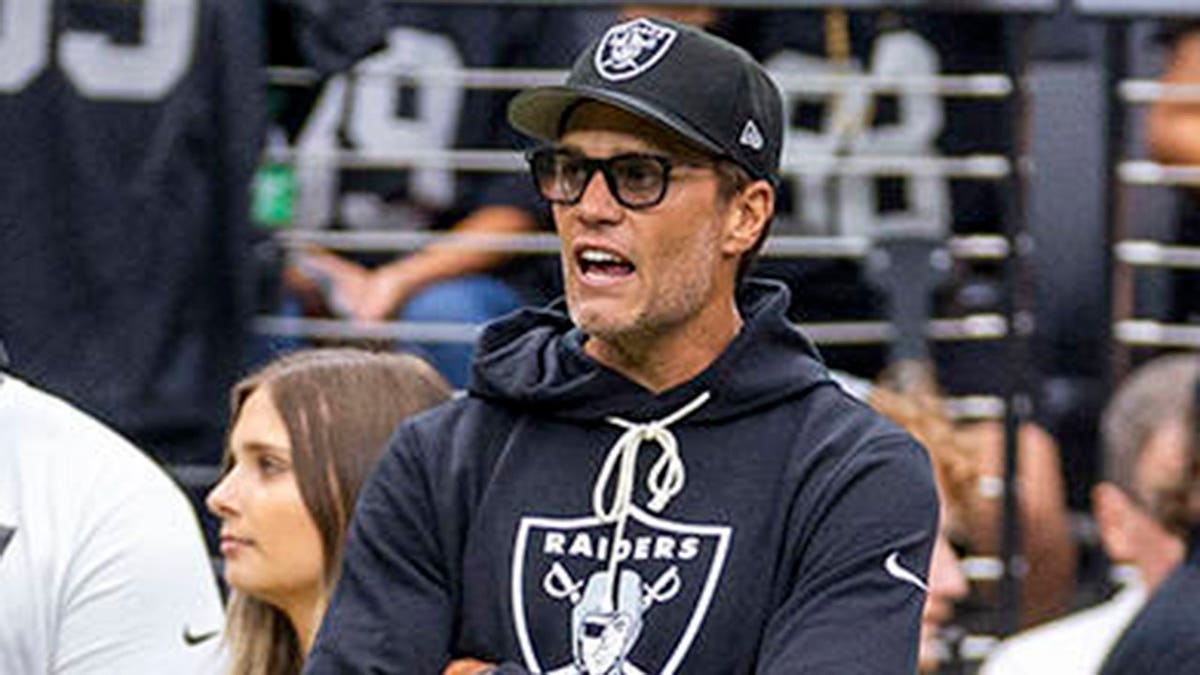 Raiders minority owner Tom Brady yelling encouragement to players on the field at Allegiant Stadium