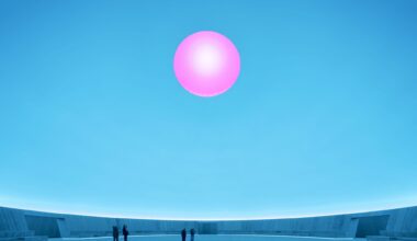 a large-scale light exhibition by James Turrell featuring a pink hole in a blue dome