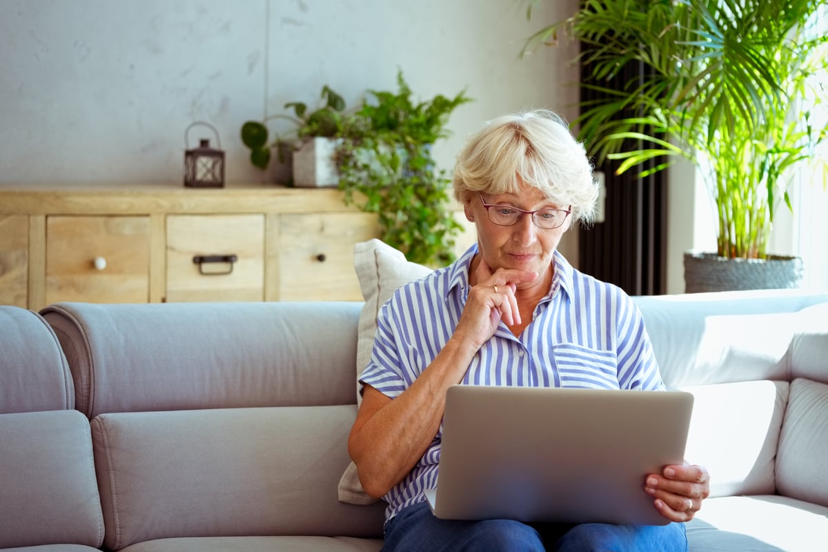A person on a couch using a laptop.