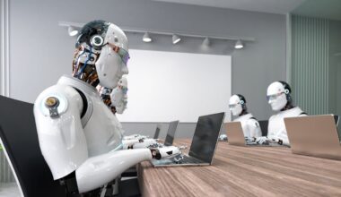 Humanoid robots working on laptops at a table.