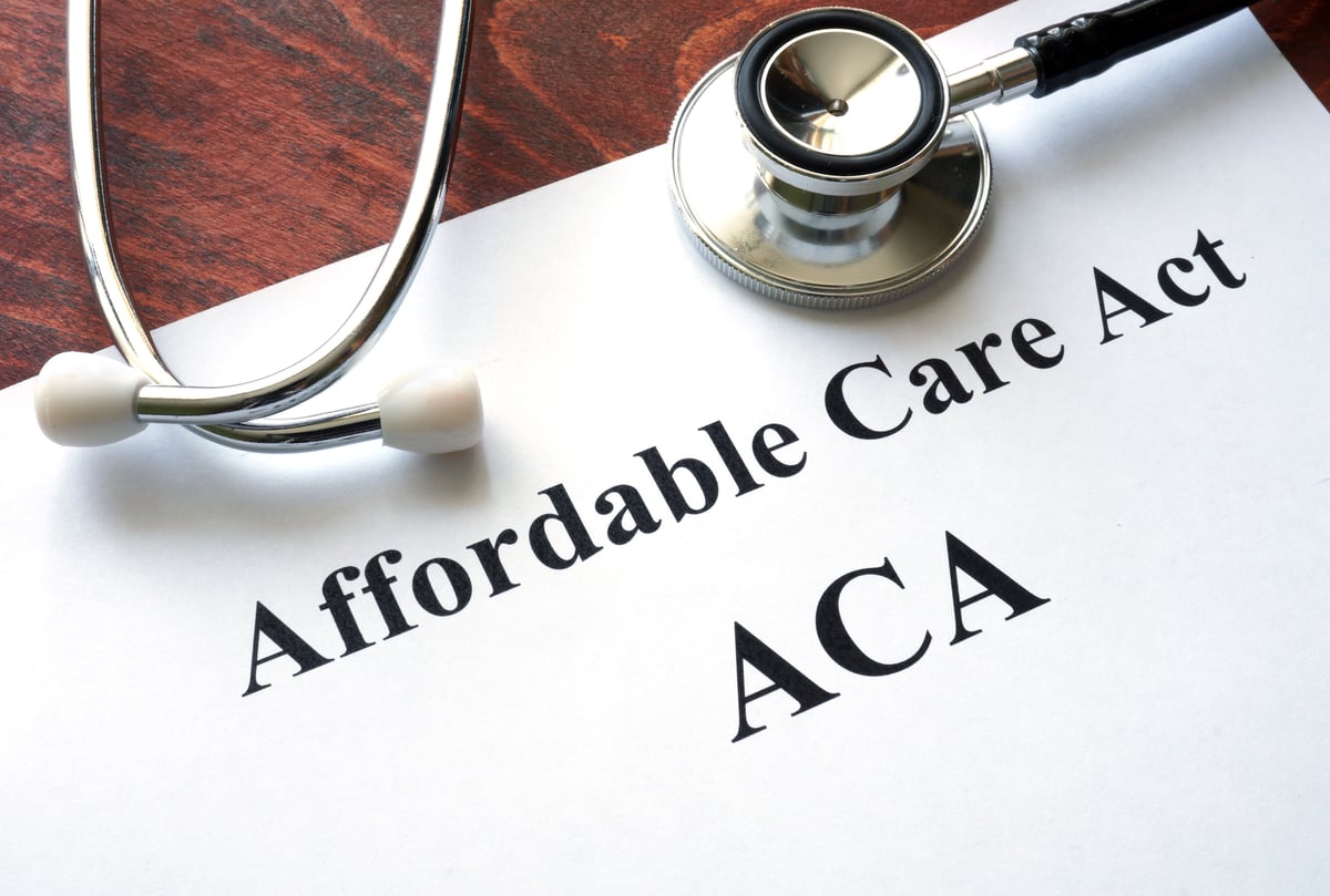 A stethoscope on top of a sheet of paper printed with the words Affordable Care Act and ACA.